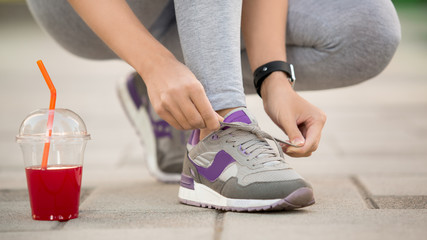  Young woman lace up snickers healthy sporty lifestyle