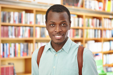 people, knowledge and education concept. attractive young afro american male with knapsack came to b