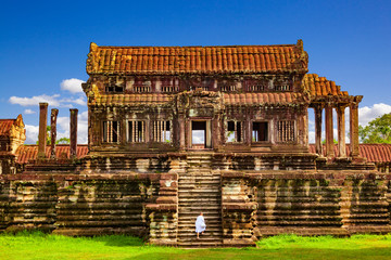 Wall Mural - Angkor Wat. Buddhist monk dressed in white arriving at North Thousand God Library. Siem Reap, Cambodia