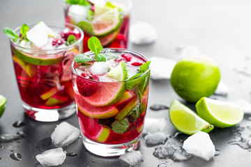 Wall Mural - Raspberry mojito cocktail with lime, mint and ice, cold, iced refreshing drink or beverage