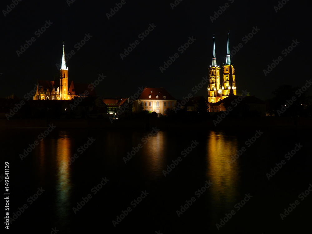 Ostrow Tumski at night. Illuminated town house and collegiate church ...