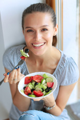 Wall Mural - A beautiful girl eating healthy food