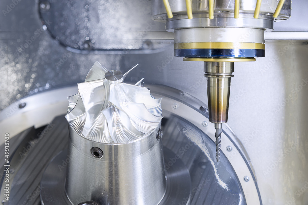 The five-axis Computer Numerical Control (CNC) machine while cutting ...
