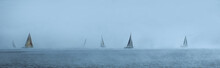 Sailing Yachts Floating In The Foggy Sea