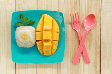 Wall Mural - mango and sticky rice on wood background.