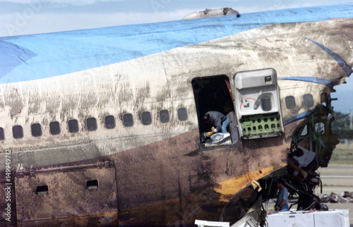 An Aviation Officer Inspects Inside A Crashed Singapore