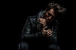 © Viorel Sima - sad man in leather jacket holding his hand while sitting
