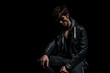 © Viorel Sima - sad dramatic biker in leather jacket sitting