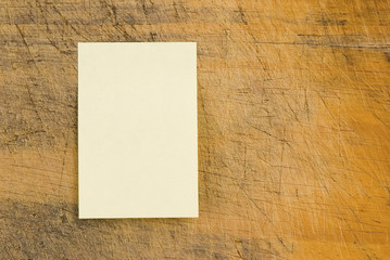 Yellow note paper on retro wood