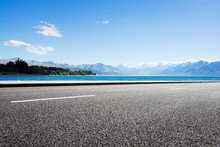 Empty Road With Blue Sea In Blue Sky
