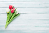 Fototapeta Tulipany - Colorful tulips over wooden background
