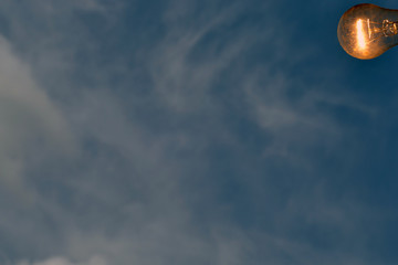 Aufkleber - Enabled light bulb on blue sky background