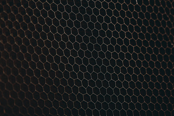 abstract texture honeycomb. Metallic net background or texture. metal mesh. full frame colourful illuminated detail of a metallic grid in front of a loudspeaker. Colorful abstract background.