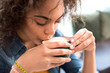 © Yakobchuk Olena - Glad girl drinking cup of beverage