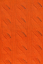 Texture Of An Orange Knitted Openwork Pattern Closeup