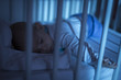 © ondrooo - Adorable baby sleeping in blue at night