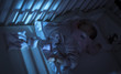 © ondrooo - Adorable baby sleeping in blue at night