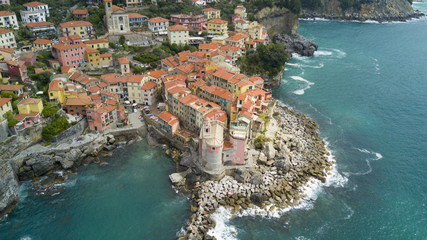 Wall Mural - Aerial video shooting with drone on Tellaro, famous Ligurian village near the Cinqueterre, small colored houses built on the cliff by the sea