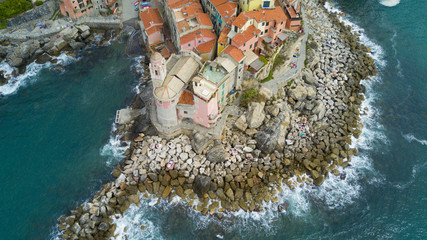 Wall Mural - Aerial video shooting with drone on Tellaro, famous Ligurian village near the Cinqueterre, small colored houses built on the cliff by the sea