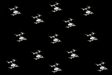 Multiple Drones Drones Pattern Hovering Against Black Sky