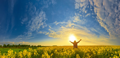 woman on flower field at sunrise