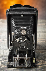 Old camera on an old background on a close-up table