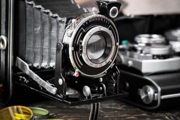 Old camera on an old background on a close-up table