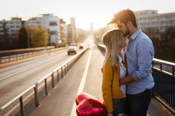 Wall Mural - Romantic young couple in love, hugging on the street