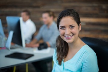 Wall Mural - Portrait of smiling businesswoman sitting on chair