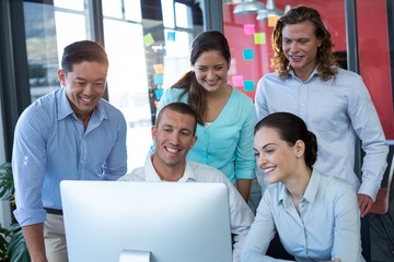 Wall Mural - Businesspeople having discussion over personal computer