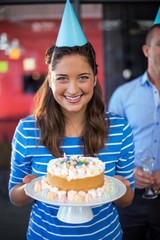 Wall Mural - Portrait of businesswoman holding cake