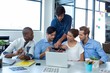 © wavebreak3 - Team of graphic designers discussing over digital tablet