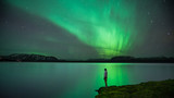 Man with Northern Lights reflection
