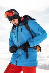  Skier tightening his backpack belt