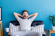 © N_studio - man yawning and going asleep in his  living room