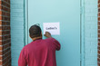 © Jordi Huisman - man putting up a sign stating the ladies room