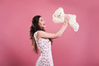 © aemstock - Beautiful girl holds a toy bear on a pink background, space for text