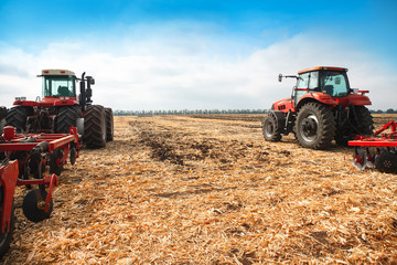 Two tractors in a field.