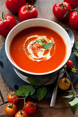 Wall Mural - Fresh homemade Tomato Soup with herbs and croutons. Creamy healthy vegetarian lunch. All decorated with fresh tomatoes and olive oil. basil.