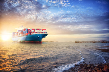 Logistics import export background of Container Cargo ship in the ocean st sunset sky, Freight Transportation