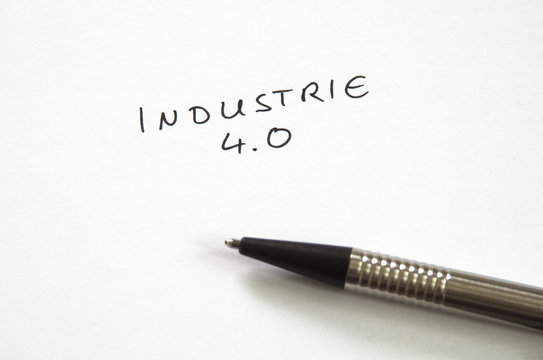 Industrie 4.0 (Industry 4.0) in handwriting on white background with pen