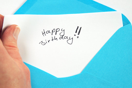 Happy Birthday, hand holding handwritten letter in blue envelope