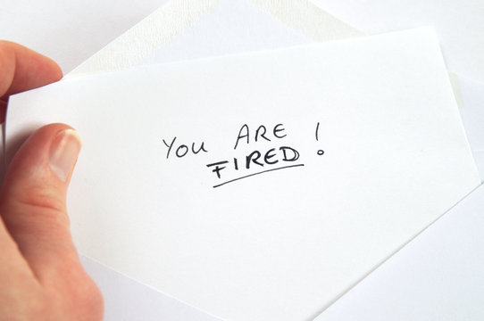 You Are Fired, hand holding employment termination letter, white envelope