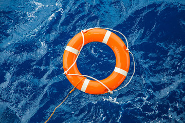 safety equipment, life buoy or rescue buoy floating on sea to rescue people from drowning man.