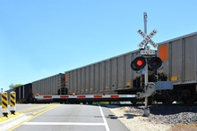 Freight Train At Crossing Gate