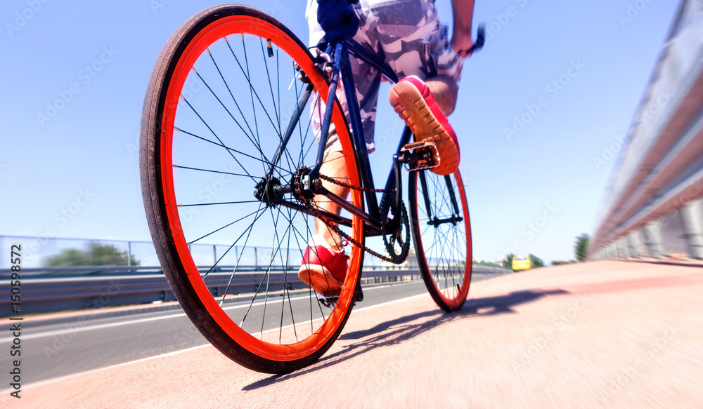 Man cycling on sport bike - Bicycle wheels and road perspective with cyclist riding  blue summer sky background - Concept of alternative transportation  environmental friendly  