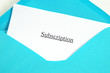 Subscription printed on white paper and blue envelope, white background