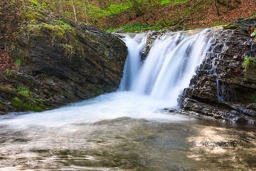 Landscape of river in mountains  and small waterfall. View of stone water rapids  and spring forest.