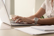 © fizkes - Close up image of womans hands typing on laptop at workplace. Businesswoman with white wristwatch on hand working on computer in office. Female office worker, programmer, entrepreneur searching online