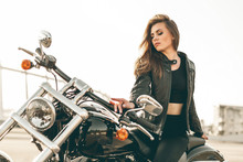 Girl On A Motorcycle. She Is Beautiful, Posing On A Motorcycle At Sunset